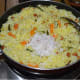 Step four: Add grated coconut. Thoroughly mix it with the rice. Add lemon juice. Once again mix well. Turn off the stove.