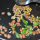 Step one: Make a tempering with mustard seeds, white lentils, split chickpeas, curry leaves, and peanuts. Saute until the mustard crackles and peanuts become crispy.