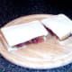 Cut to serve fish fingers and balsamic tomato sauce sandwich