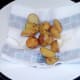 Roast potatoes are drained on kitchen paper