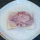 Bacon rashers are laid on houmous