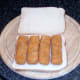 Fish fingers are laid on bottom slice of bread