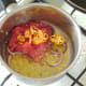 Tomatoes and chilli are added to softened onion