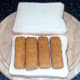 Fish fingers arranged on bread