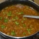 Step seven: Add vinegar. Mix well. Turn off the stove. Garnish the soup with chopped coriander leaves.