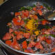 Adding the turmeric powder and sauteing.