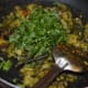 Step eight: Open the lid after 4-5 minutes. By this time, the veggies would have cooked right. Adjust the salt. Add chopped coriander leaves. Mix thoroughly once.