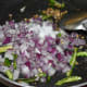 Step two: Add chopped onions, salt, and slit green chilies. Increase the heat. Saute till onions become translucent.
