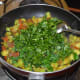 Step seven: Add chopped fenugreek leaves. Continue stir-cooking for 2-3 minutes. Cover the pan now. Let them cook inside, releasing their own water.