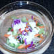 Dressing is poured over salad in a suitable bowl