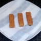 Fish fingers are drained on kitchen paper