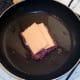 Cheese is arranged on sausage and onion