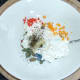 Herbs and spices are added to cream cheese