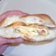 Tucking in to cheese and onion omelette and crisps sandwich