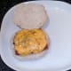 Cheesy sausage is placed on bread roll