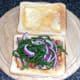 Samphire and onion is arranged on top of sardines