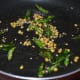 Step two: Heat oil in a deep-bottomed pan. Throw in mustard seeds and other seasonings as per instructions. Let mustard crackle.