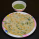 Place two urad dal pancakes on a serving plate. Serve them with a spicy coconut chutney or green chutney on the side. Enjoy!