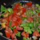 Step eight: Add chopped tomatoes. Cook till they wilt.
