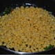 Step four: Add cooked split chickpeas. Mix them with the seasonings. Stir the mix till the water evaporates from them.