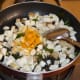 Step four: Add turmeric powder. Continue sauteing for a minute.