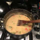 Add the yoghurt, and cook over medium-high heat until it forms a thick sauce. Strain the chicken, reserving the stock separately, and add it into the yoghurt sauce, to cook over medium heat. The yoghurt should stick to the chicken and possibly turn g