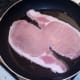 Back bacon is put on to fry