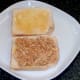 Chicken in curry sauce is spooned on to one slice of the toast