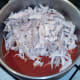 Chicken meat is added to reheated curry sauce