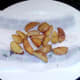 Oven cooked chips are drained on kitchen paper