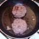 Burgers are turned to fry on second side