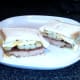 Steak, egg and chips butty is sliced and served