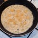 Chilli slices are added to partly set omelette