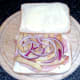 Red onion laid on paprika chips