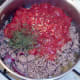 Tomatoes and chillies are added to browned lamb