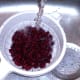 Kidney beans are washed under running cold water