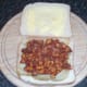 Spicy beans are spooned over chips