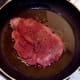 Starting to fry spiced pork steak
