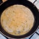 Egg is poured in to hot pan