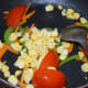 Step three: Add a fistful of fresh corn. Saute the mix for 2 more minutes.