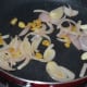 Step five: Heat olive oil in the same pan. Throw in chopped onions, garlic, and ginger. Saute them till onions become translucent.