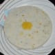 Gently pat the plate. Tatte idli falls on the serving plate. Add a spoon of ghee on it. Serve it hot with a coconut chutney or any other chutney/sauce. Enjoy the taste!