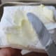 Butter paper towel to grease inside of pan.