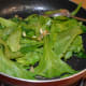 Step three: Add spinach to the sauteed ginger, garlic, and peppercorn.