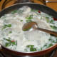 Step seven: Boil the mix for two minutes. Add sugar and salt. Turn off the stove. Put the mix in a blender or mixer. Add fresh basil. Grind them to get a smooth liquid.