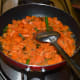 Step three: Add half a cup of water. Mix well. Reduce the heat. Cover the pan. Cook for 4-5 minutes while stirring occasionally.