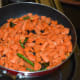 Step one: Make tempering with oil, mustard seeds, slit green chilies, and curry leaves as per instructions. Add chopped carrots.
