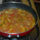 Step seven: Add 2 cups of water. Add remaining salt and sugar(optional). Stir the mix. Cover the pan. Occasionally stir it. Let the mix come to a boil. Simmer for 2 minutes.