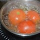 Step two: Boil whole tomatoes in water until the skins open a little.