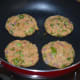 Step three: Take a lemon-sized portion of the mixture. Shape it like a patty. Make 4 such shapes. Shallow-fry them in a pan.